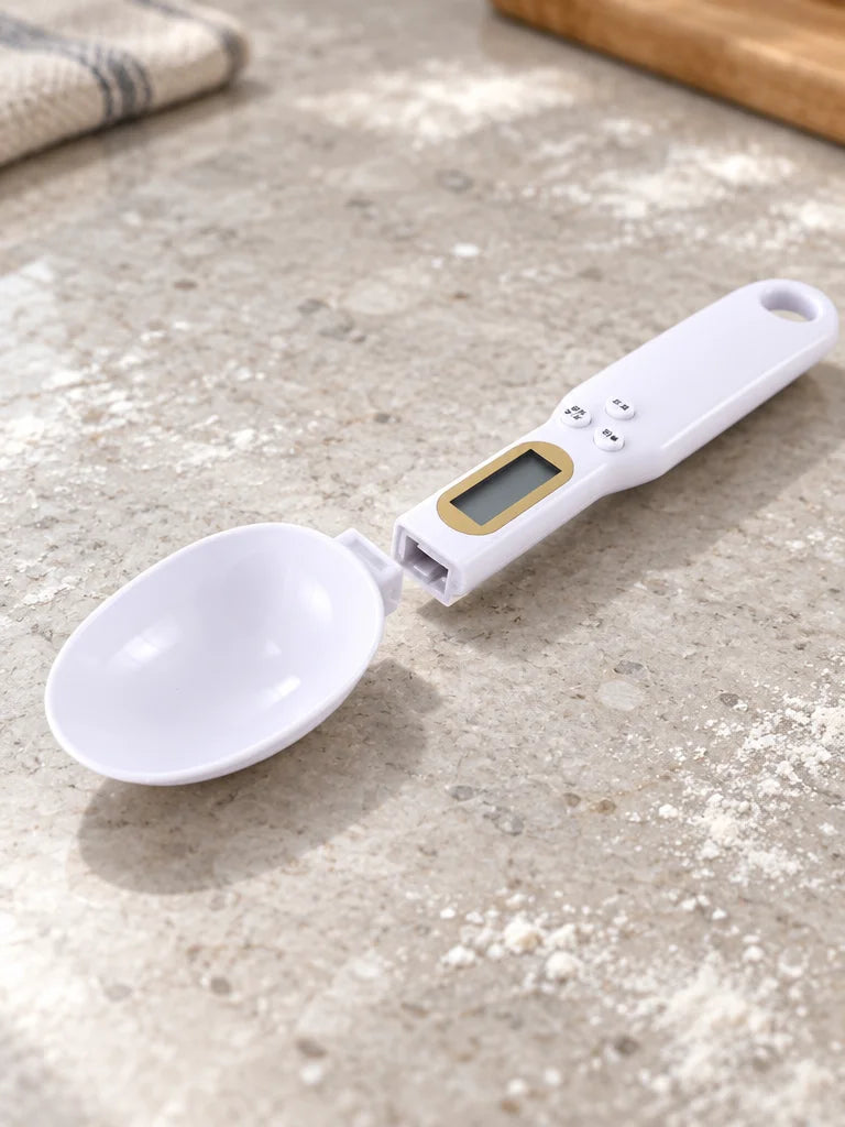 A close product photograph of the exact detachable white spoon head and handle arranged apart on a l