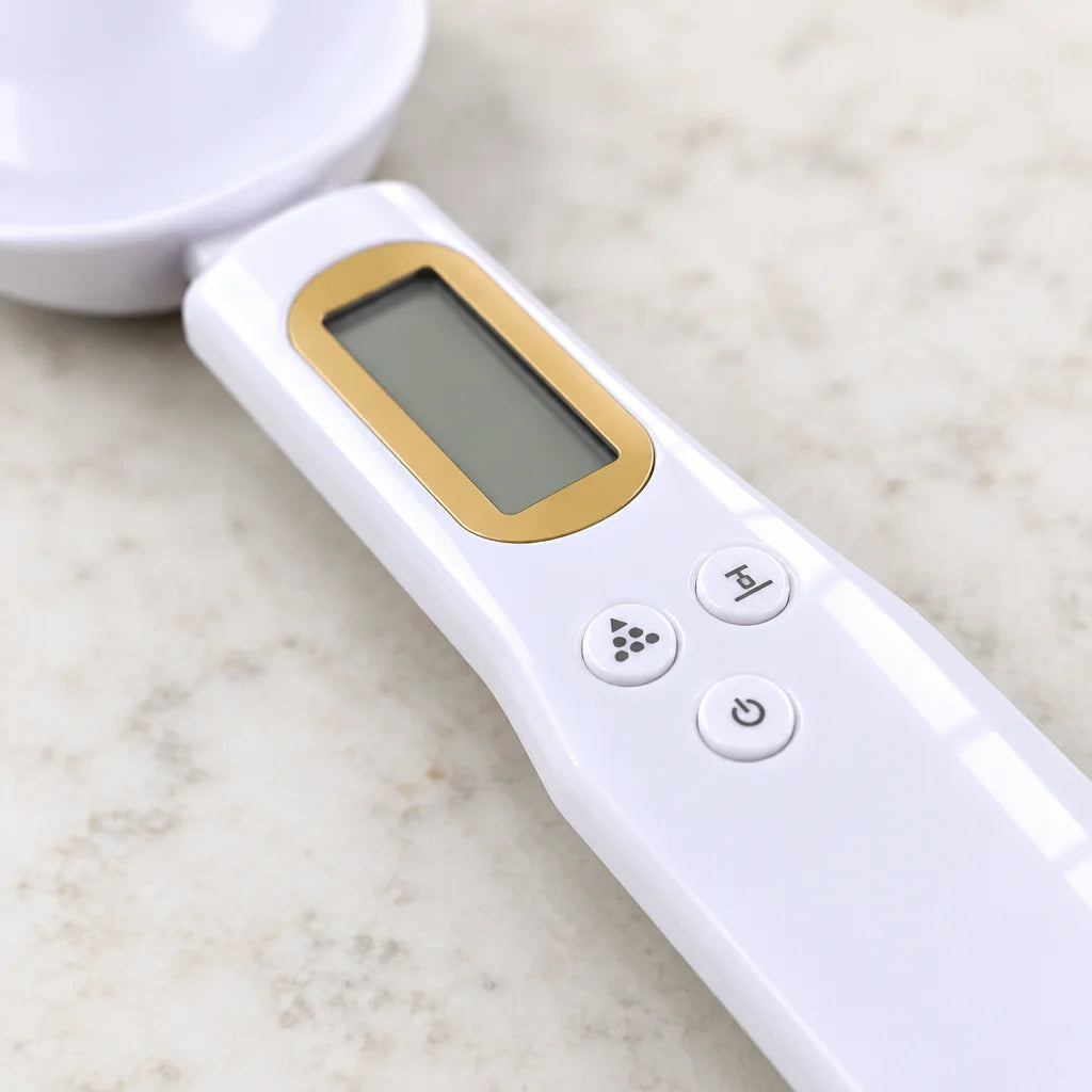 A tight macro of the white digital spoon’s handle, showing the tan surround around its LCD and all t